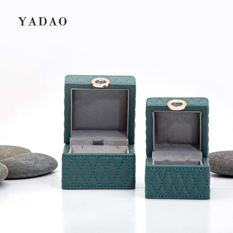 Dark green color leatherette box with stitching design around the whole box