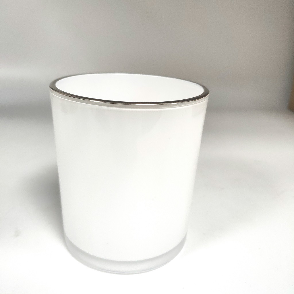 white gllass candle jar with shiny silver gold rim