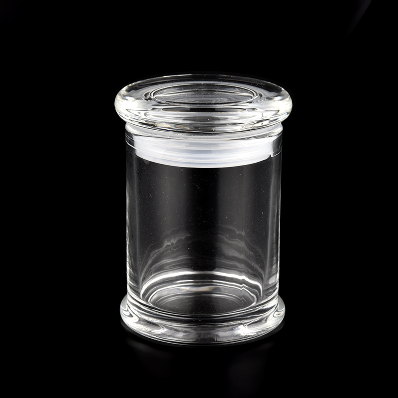 Tall column style clear glass candle jars paired with glass lids