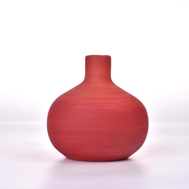 ceramic diffuser bottle with red swirl pateern