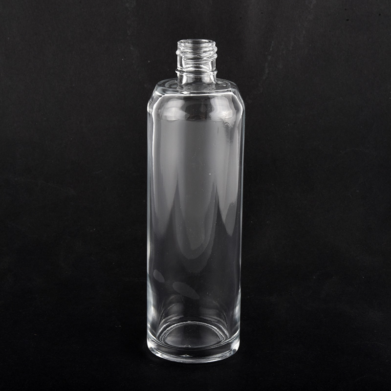 Botella de perfume de cristal vacía de forma redonda elegante