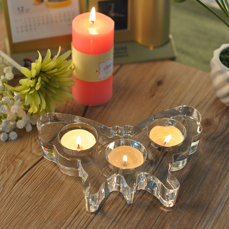 Glass candle holder in butterfly shape