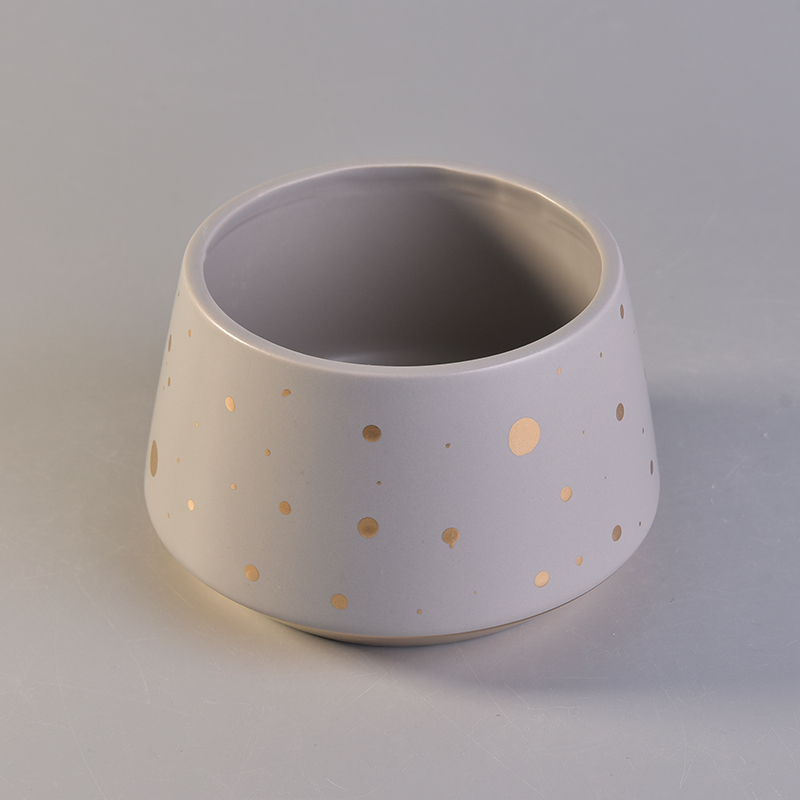 Unique shape ceramic candle vessel with gold color dots