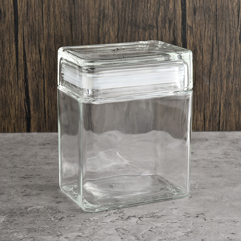 gran frasco de vidrio rectangular con velas de tapa