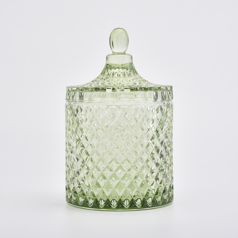 ふたの家の装飾が付いている贅沢な緑のガラス蝋燭の瓶