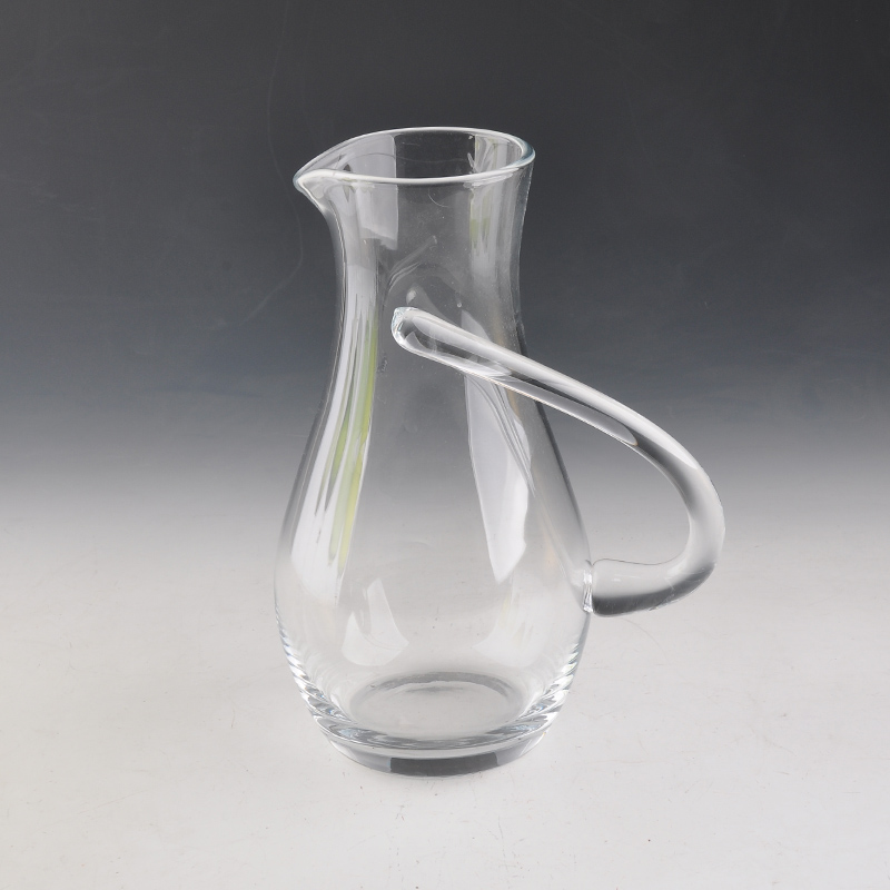 round glass decanter with hand