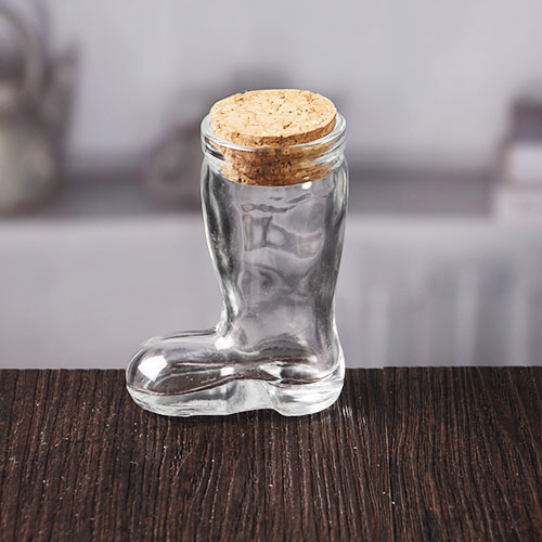 Small transparent unique boot shaped glass bottle with cork lid